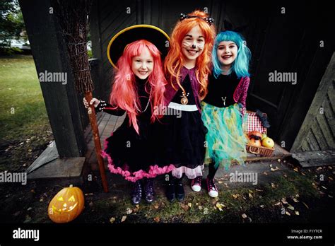 Halloween Witches Looking At Camera By Haunted House Stock Photo Alamy