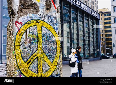 Berlin wall fragment with peace sign in Potsdamer Platz, Berlin, Germany Stock Photo - Alamy