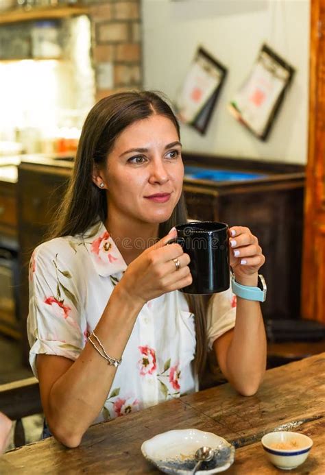Portrait Of Smiling Russian Woman Drinking Hot Capuccino And Looking Right Stock Photo Image