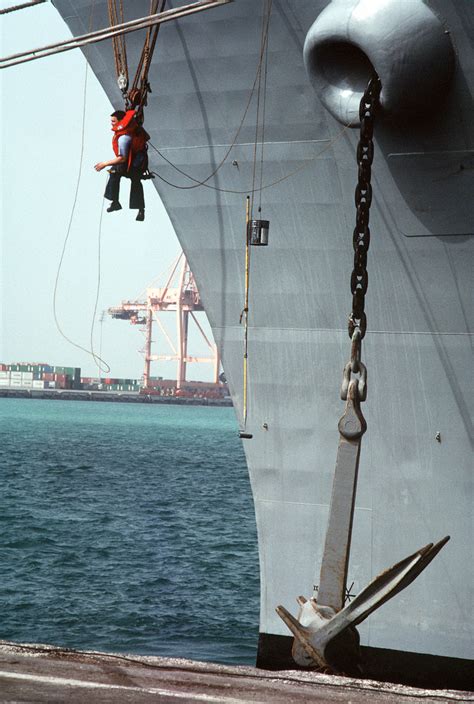 A Sailor Prepares To Touch Up The Paint On A U S Navy Ship During