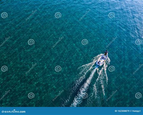 Aerial View Of A Rowing Boat Seen From Above Powered By An Engine