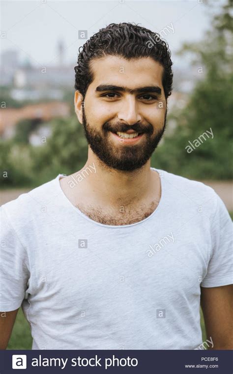 Download this stock image: Outdoor portrait of cheerful Syrian man ...