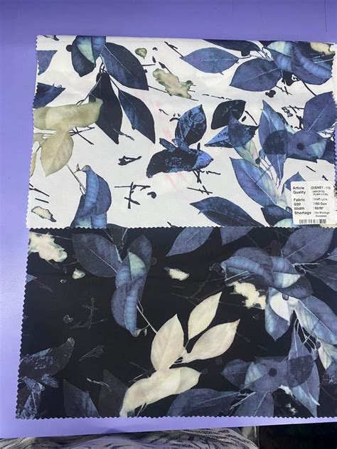 Blue And White Fabric With Leaves On It Sitting Next To A Purple Table