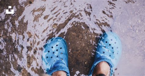 A Person Wearing Blue Shoes Standing In Water Photo Free Blue Image