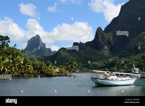 Boat In Cooks Bay With Moua Puta Mountain On The Tropical Pacific