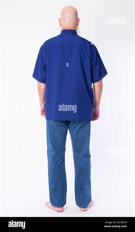 Full Body Shot Rear View Of Mature Bald Man With Long Gray Beard Stock