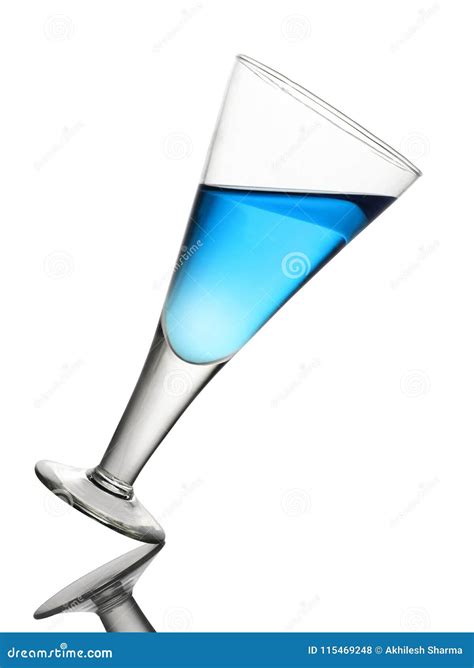 Tilted Wine Glass With Blue Drink On White Background Stock Photo