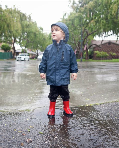 Caucasian Boy Standing In Rain Stock Photo Dissolve