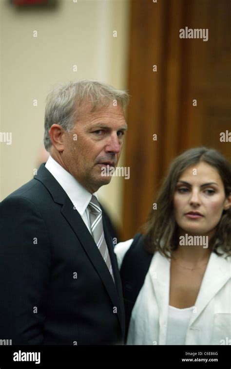 Kevin Costner speaks to Annie Costner before testifying about the oil ...