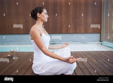 Peaceful Brunette In White Sitting In Lotus Pose Stock Photo Alamy