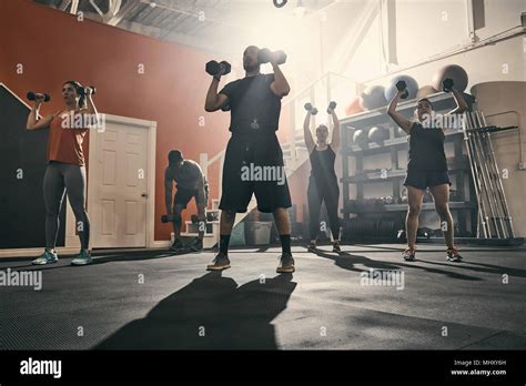 Man Using Dumbbells In Gym Stock Photo Alamy