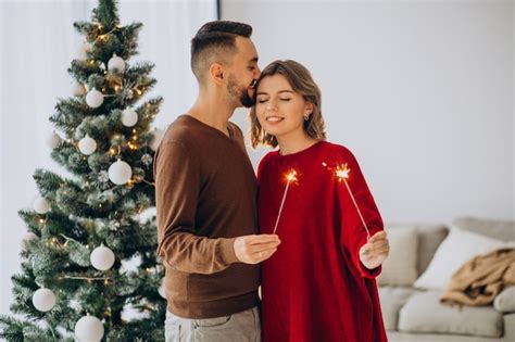 Pareja Celebrando La Navidad Juntos En Casa Foto Gratis