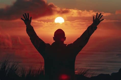 Premium Photo Silhouette Of A Man With Hands Raised In The Sunset