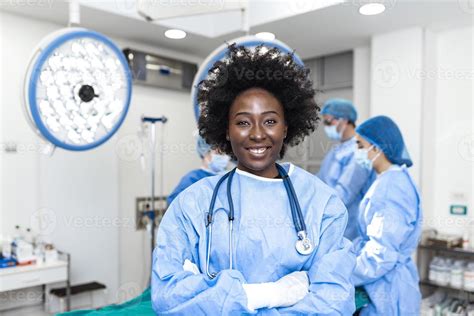 Portrait Of Happy African American Woman Surgeon Standing In Operating