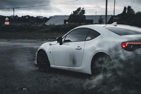 White Subaru Brz In Gravel Parking Lot · Free Stock Photo