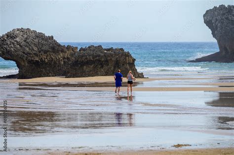 Couple Running On Playa De Palombina Las Camaras In Celorio Green