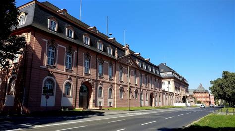 An Old Building On The Side Of A Road With Cars Parked In Front Of It