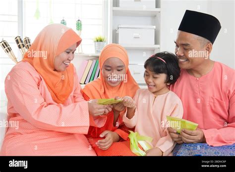 Woman Giving Green Packet To The Girls During Hari Raya Malay Or