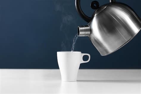 Premium Photo Retro Kettle Pouring Water Into A Cup On A White