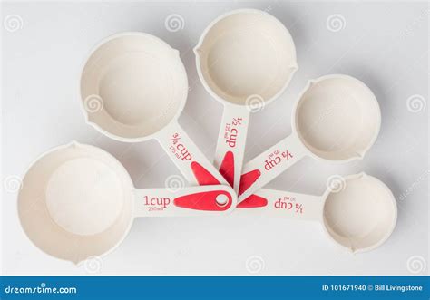 Set Of Fanned Measuring Cups On White Background Top View Stock Photo