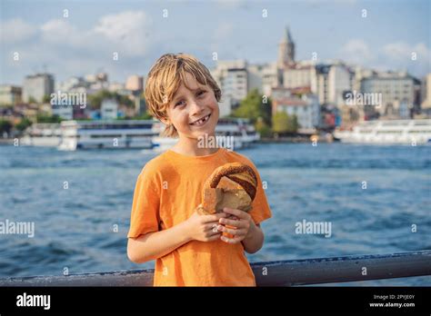 Boy In Istanbul Having Breakfast With Simit And A Glass Of Turkish Tea