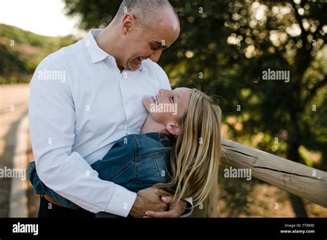 Dad And Daughter Hugging And Smiling At One Another In Socal Stock