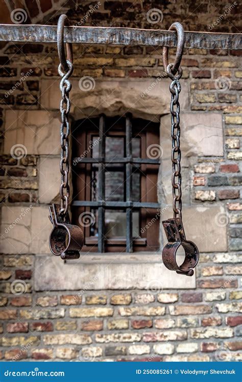 Slavery And Bondage Strong Steel Old Shackles On Bricks Background