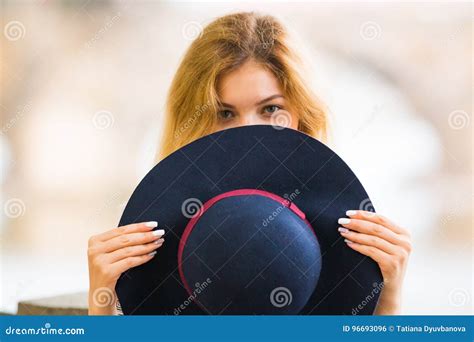 Portrait Of The Beautiful Fashionable Girl Playing With Hat Outdoor