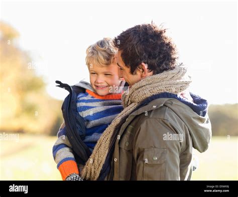 Father Carrying Son Outdoors Stock Photo Alamy