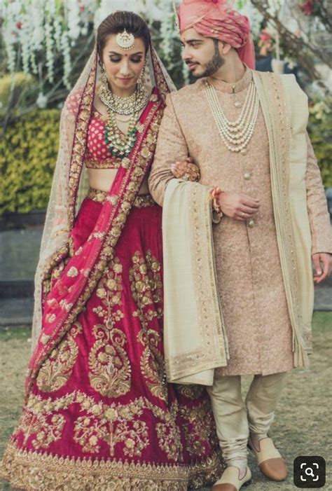 Bride And Groom In Red Traditional Indian Wedding Att