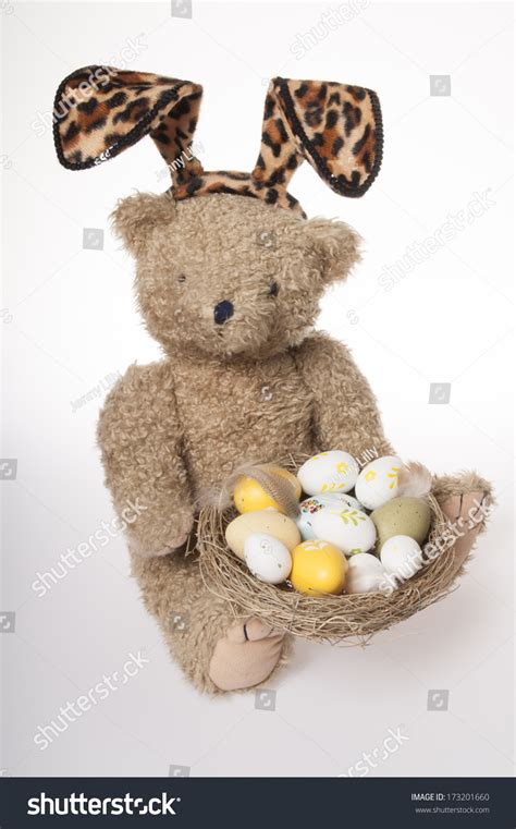 Easter Teddy Bear Dressed In Bunny Ears With Easter Eggs Isolated On