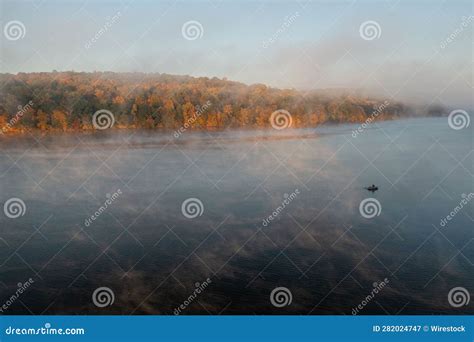 Picturesque Landscape Featuring A Foggy Forest Near The Shore Of A Body