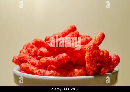 A Close View Of Flamin Hot Cheetos Reveals The Spicy Chili Cheese Powder Seasoning That Coats