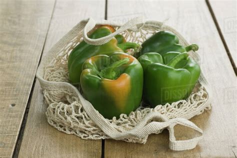 Fresh Green Bell Peppers In Mesh Shopping Bag Stock Photo Dissolve