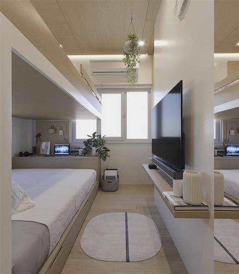 A Bedroom With Two Beds And A Flat Screen Tv On The Wall In Front Of It