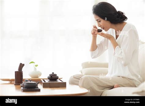 Mature Woman Drinking Tea In Living Room Stock Photo Alamy