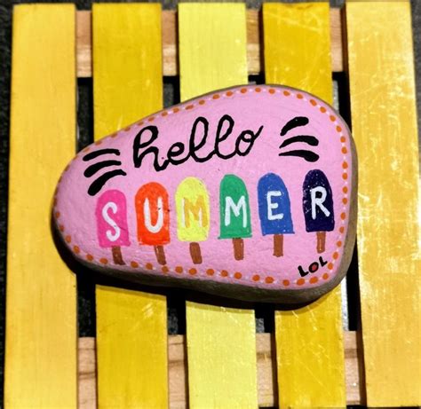 A Painted Rock With The Words Hello Summer On It Sitting On Yellow And