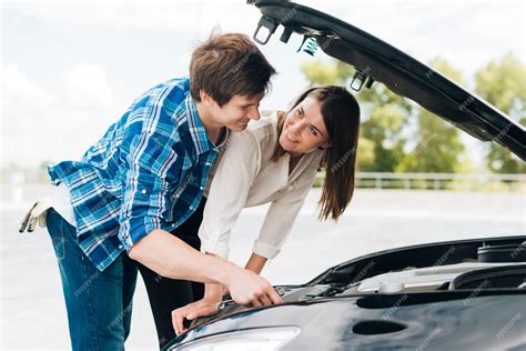 Free Photo Man Helps Woman Fix Her Car