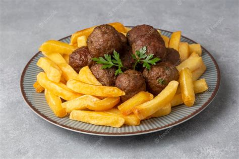 Premium Photo Round Shaped Balls Of Dry Meatballs And French Fries