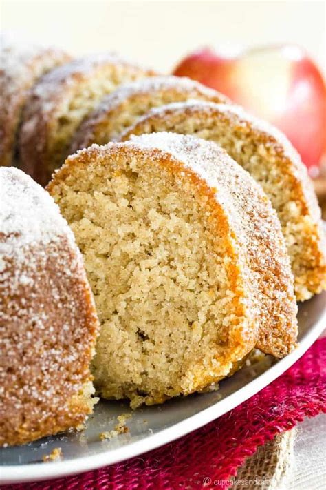 An Apple Cider Bundt Cake Cut In Half On A Plate