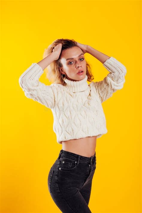 Portrait Of A Skinny Fashionable Brunette Woman In Jeans And A Blue Sweater Stock Photo Image