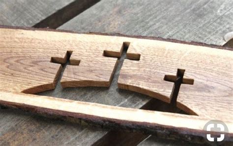 Three Wooden Crosses Sitting On Top Of A Table