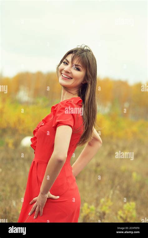 Autumn Portrait Of A Beautiful Brunette Middle Aged Woman In A Red