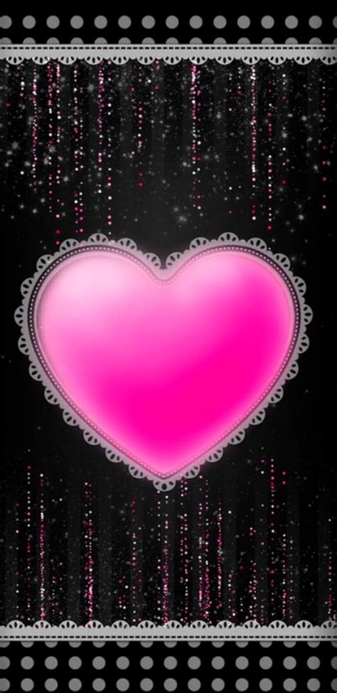 A Pink Heart On A Black Background With White Dots And Sparkles In The