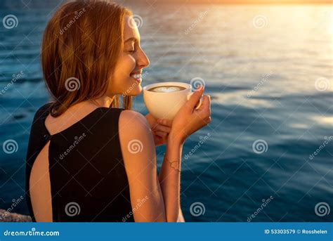 Young Woman Drinking Coffee On The Pier At Sunrise Stock Image Image