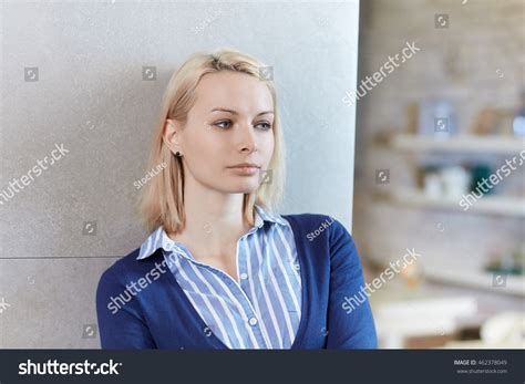 Thoughtful Young Woman Leaning Against Wall Stock Photo 462378049