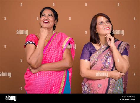 Two Happy Mature Indian Woman Thinking And Looking Up Stock Photo Alamy