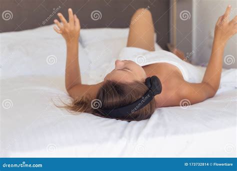 Beautiful Naked Woman In Headphones Listening Music Lying On A Bed In