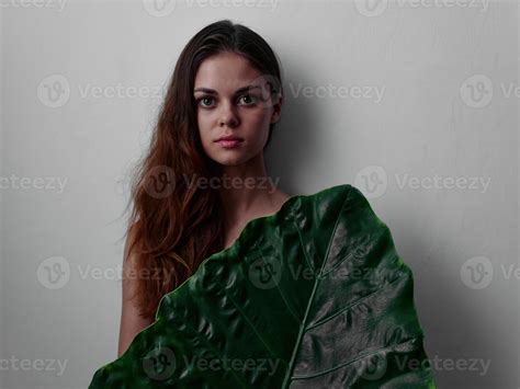 Pretty Red Haired Woman With Naked Body Covered With Palm Leaf Light