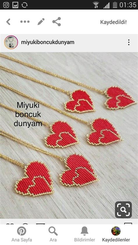 Four Red Heart Shaped Pendants Are Shown On A White Table With The